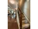Traditional staircase with wooden banister, carpeted steps, and natural light from nearby windows at 3455 Buffington Ln, Cumming, GA 30040