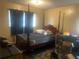 Bedroom with a four-poster bed, a ceiling light, and visible window with curtains at 4632 Burks Rd, Forest Park, GA 30297