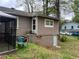 Back exterior of home with siding, steps leading to the back door, and lower-level entrance at 4632 Burks Rd, Forest Park, GA 30297