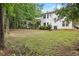 Spacious backyard featuring mature trees, lush green grass, and well-maintained landscaping at 995 Litchfield Pl, Roswell, GA 30076
