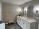 Bright bathroom with double sinks, white cabinets, a large countertop, and modern fixtures at 995 Litchfield Pl, Roswell, GA 30076