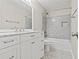 Updated bathroom with patterned tile floors, white vanity, and gray tiled shower at 995 Litchfield Pl, Roswell, GA 30076