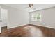 Bright bedroom features wood floors, a ceiling fan, and an open closet at 995 Litchfield Pl, Roswell, GA 30076