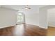 Bright bedroom features wood floors, a ceiling fan, and closet at 995 Litchfield Pl, Roswell, GA 30076