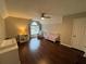 Well-lit bedroom with wood floors, a ceiling fan, a window, and neutral paint at 995 Litchfield Pl, Roswell, GA 30076