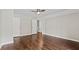 Bedroom features a ceiling fan, neutral walls, and wood floors at 995 Litchfield Pl, Roswell, GA 30076
