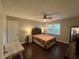 Bright bedroom with wood floors, a window, ceiling fan, and a tufted headboard at 995 Litchfield Pl, Roswell, GA 30076