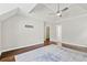 Bright primary bedroom with modern ceiling fan, dark hardwood floors, a large rug, and closet access at 995 Litchfield Pl, Roswell, GA 30076