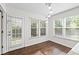 Bright breakfast nook features wood floors, a pendant light, and multiple windows offering a beautiful view at 995 Litchfield Pl, Roswell, GA 30076