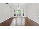 Bright dining room with hardwood floors and ample natural light from the bay windows at 995 Litchfield Pl, Roswell, GA 30076