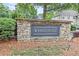Whitehall community entrance featuring stone and pine straw landscaping at 995 Litchfield Pl, Roswell, GA 30076
