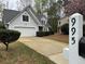 Charming two-story home with a driveway, an attached garage, and mature trees at 995 Litchfield Pl, Roswell, GA 30076