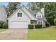 Charming home featuring stone accents, a two-car garage, and a well-maintained lawn at 995 Litchfield Pl, Roswell, GA 30076