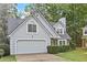 Charming home featuring stone accents, a two-car garage, and a well-maintained lawn at 995 Litchfield Pl, Roswell, GA 30076