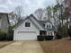 Charming home featuring a two-car garage, stone accents, and a well-maintained front yard at 995 Litchfield Pl, Roswell, GA 30076
