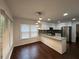 Updated kitchen features granite countertops, stainless steel appliances, and modern lighting at 995 Litchfield Pl, Roswell, GA 30076