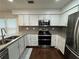 Well-appointed kitchen featuring granite countertops, stainless steel appliances, and ample storage at 995 Litchfield Pl, Roswell, GA 30076