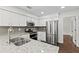 Modern kitchen featuring stainless steel appliances, white cabinets, and granite countertops at 995 Litchfield Pl, Roswell, GA 30076