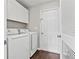 Laundry room features a washer, dryer, and additional cabinet space for storage at 995 Litchfield Pl, Roswell, GA 30076