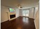 Bright living room featuring a decorative fireplace, wood floors, and a ceiling fan at 995 Litchfield Pl, Roswell, GA 30076