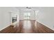 Bright living room featuring hardwood floors, white trim, and a fireplace at 995 Litchfield Pl, Roswell, GA 30076