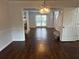 Open-concept living room and dining area with hardwood floors and lots of natural light at 995 Litchfield Pl, Roswell, GA 30076