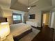 Comfortable main bedroom with a large window, ceiling fan, TV, and neutral paint at 995 Litchfield Pl, Roswell, GA 30076