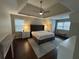 Spacious main bedroom with a tray ceiling, ceiling fan, and abundant natural light at 995 Litchfield Pl, Roswell, GA 30076