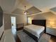Spacious main bedroom featuring tray ceilings, ceiling fan, ensuite bathroom, and neutral paint at 995 Litchfield Pl, Roswell, GA 30076