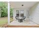 Outdoor patio with a white ceiling, two chairs, a small table, and lots of greenery at 995 Litchfield Pl, Roswell, GA 30076
