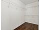 Walk-in closet with hardwood floors, white walls, and wire shelf storage at 995 Litchfield Pl, Roswell, GA 30076