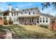 Backyard showing covered porch with dark wooden columns, ample space, and manicured landscaping at 3080 Dickson Ne St, Brookhaven, GA 30319