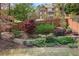 View of backyard showing landscaping leading to a two-story home with a stone chimney and outdoor porch at 3080 Dickson Ne St, Brookhaven, GA 30319