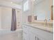 Bright bathroom featuring a shower and white vanity with granite countertop at 3080 Dickson Ne St, Brookhaven, GA 30319