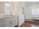 Bathroom features a marble countertop vanity, a clawfoot tub and hardwood floors at 3080 Dickson Ne St, Brookhaven, GA 30319