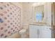 Bright bathroom featuring polka dot shower curtain, white cabinetry, and granite countertop at 3080 Dickson Ne St, Brookhaven, GA 30319