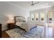 Serene bedroom with natural light, hardwood floors, a comfortable bed, and a large area rug at 3080 Dickson Ne St, Brookhaven, GA 30319