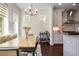 Elegant dining area with shiplap walls, stylish lighting, and view of backyard at 3080 Dickson Ne St, Brookhaven, GA 30319