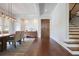 Open dining room showcases hardwood floors and a view of the staircase, door and backyard at 3080 Dickson Ne St, Brookhaven, GA 30319