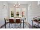 Cozy dining area featuring shiplap walls, large windows, and a view of lush landscaping at 3080 Dickson Ne St, Brookhaven, GA 30319
