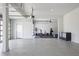 Open concept garage with three doors, plenty of storage, and a dedicated home gym area at 3080 Dickson Ne St, Brookhaven, GA 30319