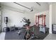 Bright home gym with black flooring, weight training equipment, and an Everlast punching bag in a spacious garage at 3080 Dickson Ne St, Brookhaven, GA 30319