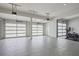 Spacious garage with three frosted glass doors, ample storage, and an area set up as a workout space at 3080 Dickson Ne St, Brookhaven, GA 30319