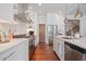 Well-equipped kitchen featuring stainless steel appliances, ample counter space, and a view of the staircase at 3080 Dickson Ne St, Brookhaven, GA 30319