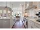 Modern kitchen with stainless steel appliances, a central island, and an open layout leading to the dining area at 3080 Dickson Ne St, Brookhaven, GA 30319