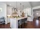 Beautiful kitchen showcasing an island with seating, pendant lighting, stainless appliances, and hardwood flooring at 3080 Dickson Ne St, Brookhaven, GA 30319