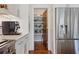 Bright kitchen with modern appliances, a pantry, a stainless steel refrigerator, and ample storage space at 3080 Dickson Ne St, Brookhaven, GA 30319