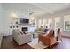 Cozy living room features hardwood floors, a fireplace, built-in shelving, and plenty of natural light at 3080 Dickson Ne St, Brookhaven, GA 30319