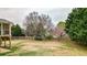 Large, fenced backyard with mature trees provides privacy and space for outdoor activities, offering an outdoor oasis at 6675 Flagstone Ct, Cumming, GA 30028