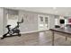 Finished basement area with luxury vinyl flooring, workout space, and walkout to the backyard at 6675 Flagstone Ct, Cumming, GA 30028